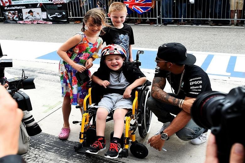 Lewis Hamilton with young fans on Thursday before the US Grand Prix. Winning a third world championship would place him on par with some of the sport's greats like Jack Brabham, Jackie Stewart, Niki Lauda, Nelson Piquet and Ayrton Senna.