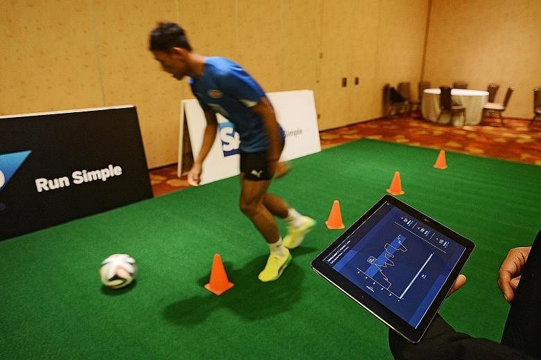 Home United goalkeeper Zulfairuuz Rudy demonstrating SAP's Injury Risk Monitor for the first time in South-east Asia at the software company's regional media summit yesterday.
