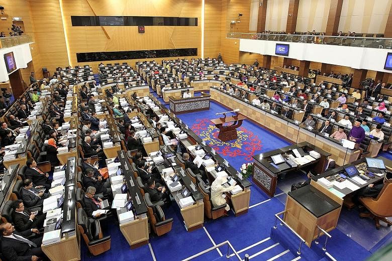Malaysian Prime Minister Najib Razak (standing on the right, dressed in purple), delivering his Budget speech in Parliament on Friday.