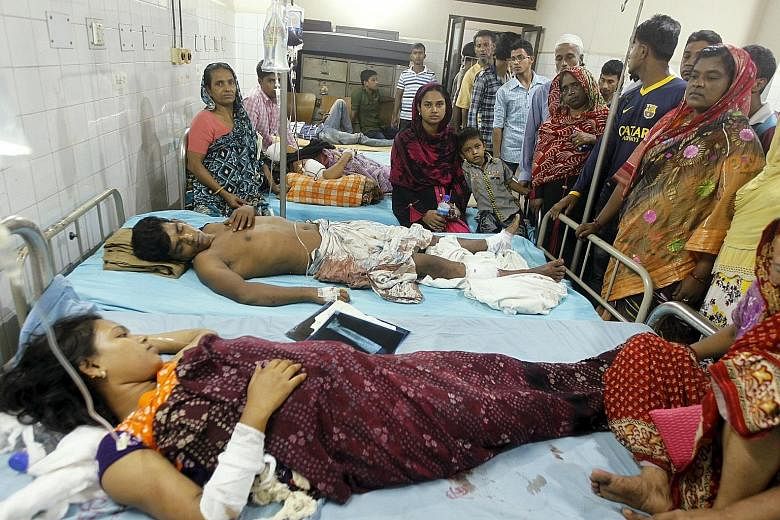 People injured in the blasts in Dhaka recovering in hospital yesterday with relatives gathered around them.