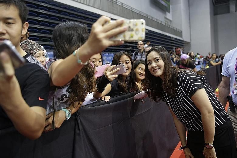 Retired Chinese tennis star Li Na, still a favourite off court, taking selfies with fans at the OCBC Arena before a WTA Rising Stars match.