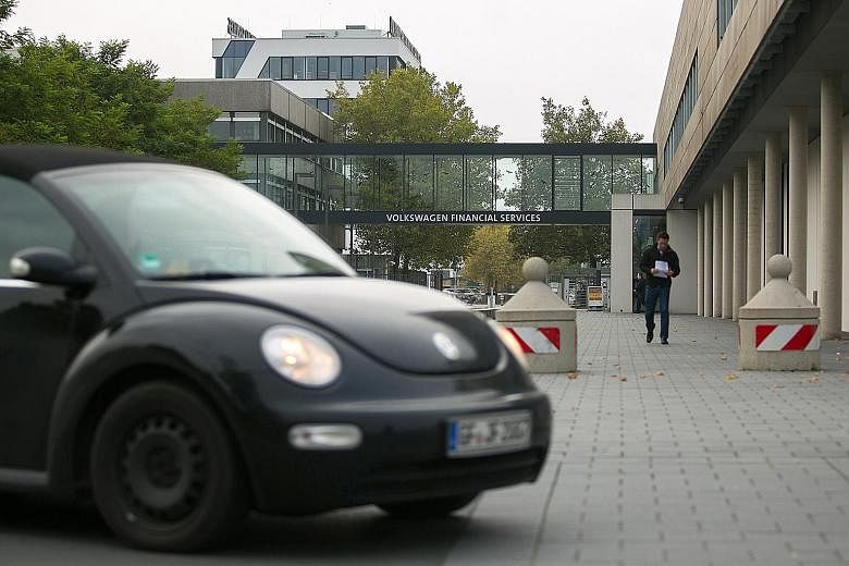 A Volkswagen Beetle outside the offices of Volkswagen Financial Services in Braunschweig, Germany. The vehicle maker has admitted that 11 million of its diesel cars were fitted with devices to fool regulators into thinking that the cars were hitting 