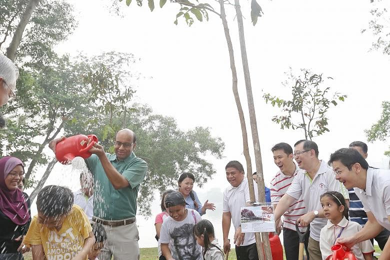 It wasn't just the trees at Jurong Lake Park that got a watering yesterday from Deputy Prime Minister Tharman Shanmugaratnam. After planting a Malayan crepe myrtle tree with others, Mr Tharman also gave Aw Jun Le, nine, a sprinkling of water.