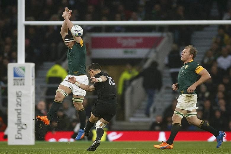 Above: All Blacks' first-five Dan Carter letting fly with a sweetly struck drop goal to help turn the momentum in Saturday's Rugby World Cup semi-final against South Africa. Right: Sonny Bill Williams (right) thanks the heavens after New Zealand win 