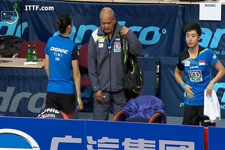 From left: Yu Mengyu, coach Hao Anlin and Feng Tianwei at the Polish Open women's doubles final yesterday, a day after the issue surfaced.