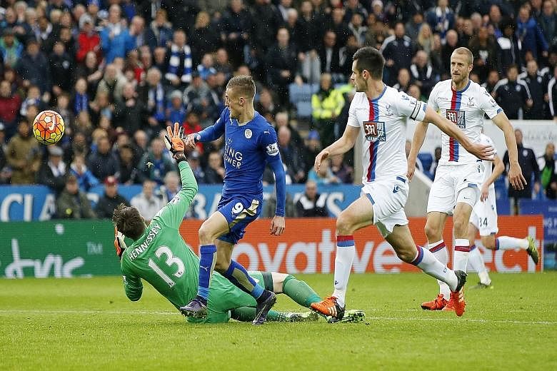Jamie Vardy chipping the ball over Wayne Hennessey into an empty goal for Leicester's winner against Palace. He is the eighth player to score in seven league games running.