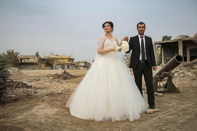 A Kurdish couple posing for a wedding shot in war-ravaged Kobani on Friday. The area is controlled by Kurdish-led forces. In the previous presidential election, Kurdish officials said they would not allow the Assad regime to open polling stations in 