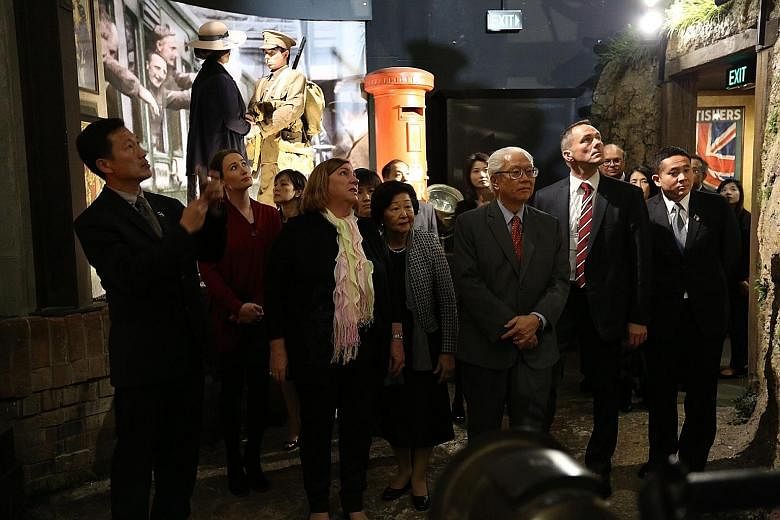 President Tony Tan and his wife Mary taking a tour of the Great War Exhibition at the Dominion Museum in Wellington yesterday. On the far left is Acting Minister for Education (Higher Education and Skills) Ong Ye Kung.