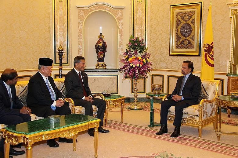 Foreign Minister Vivian Balakrishnan (third from left) having an audience with Brunei's Sultan Haji Hassanal Bolkiah (right) yesterday during his first introductory visit.