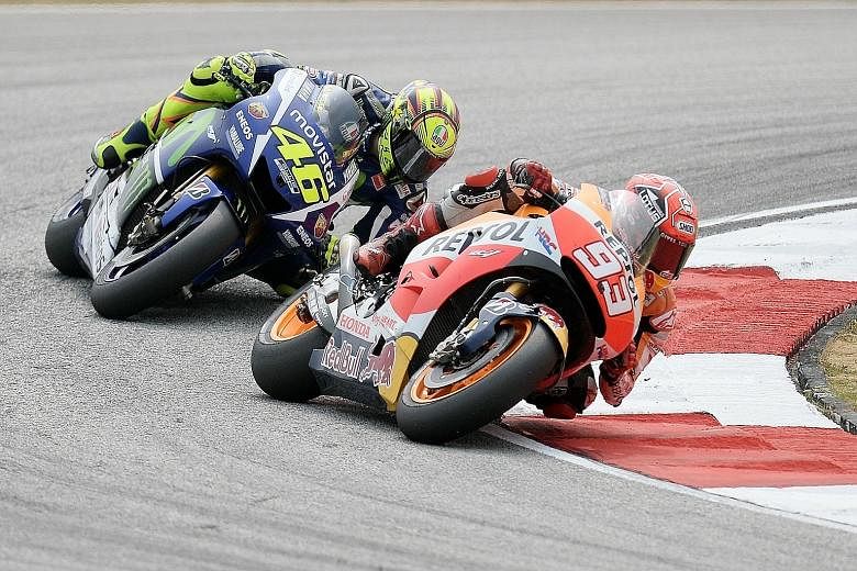 Honda's Marc Marquez (right) and Yamaha's Valentino Rossi in action during the Malaysian Grand Prix.Rossi is facing a grid penalty for the final race after he was adjudged to have kicked out at Marquez.