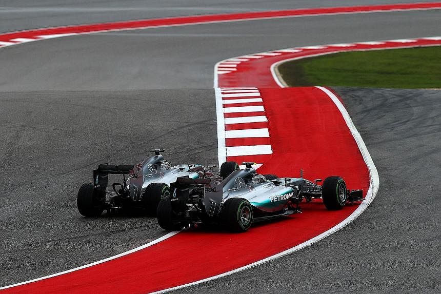 Hamilton (left) making contact with Rosberg at Turn 1, with the German being pushed wide. Hamilton later insisted he was not aggressive.