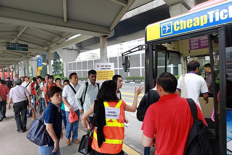 Commuters taking the bus outside Serangoon MRT station yesterday morning after NEL train services broke down owing to a power fault, affecting some 41,000 people during the morning rush hour.