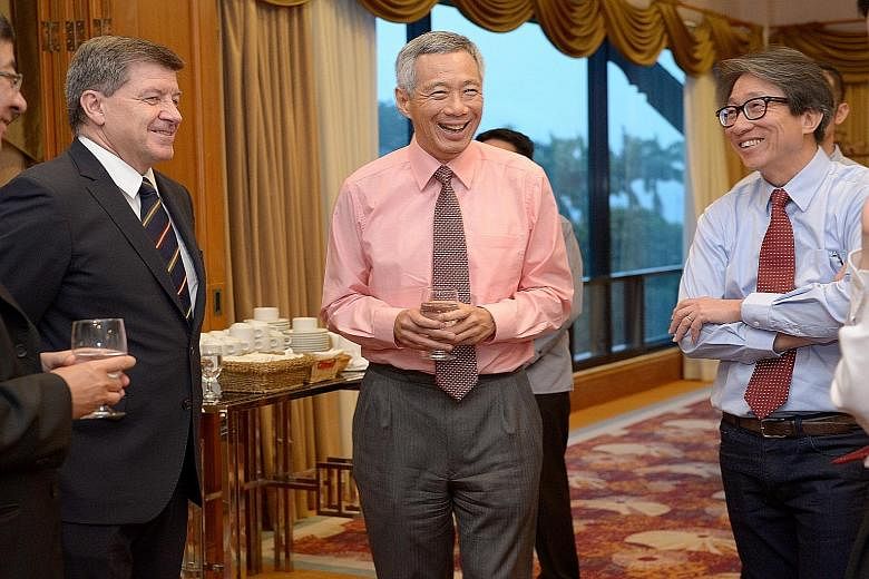 Prime Minister Lee Hsien Loong (centre) with International Labour Organisation director-general Guy Ryder (left) and Manpower Minister Lim Swee Say at the National Delegates Conference opening dinner, held at Orchid Country Club, last night.