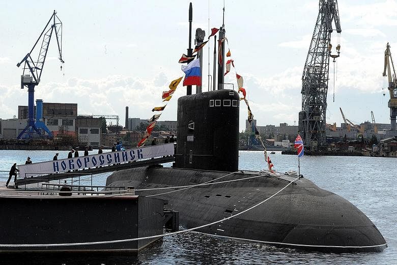 A Russian crew boarding a submarine in St Petersburg last year. Last month, Russian spy ship Yantar, equipped with two self-propelled deep-sea submersible craft, cruised slowly off the US East Coast on its way to Cuba - where one cable lands near the