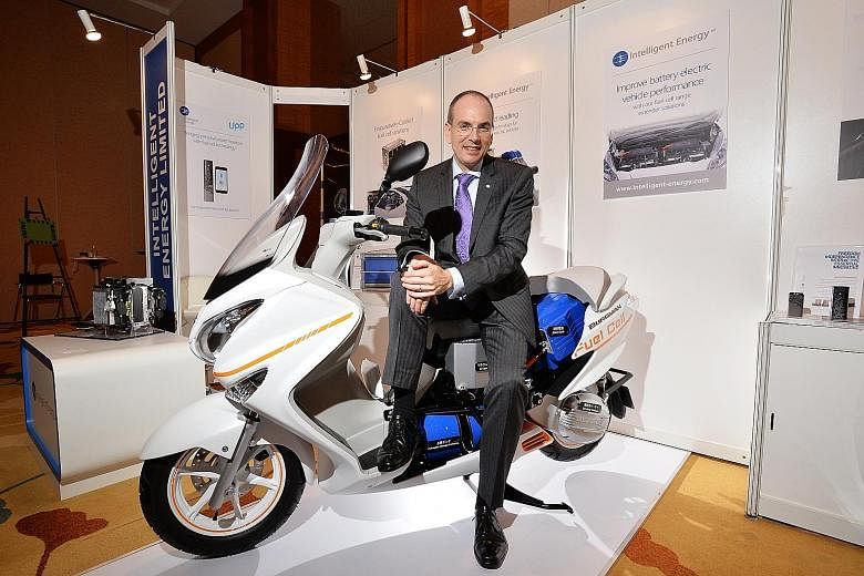 Mr Henri Winand, CEO of Intelligent Energy, sitting on a fuel cell-powered Suzuki scooter. The company will be collaborating with four major vehicle manufacturers to make fuel cell models. It has worked with Suzuki for the last decade.