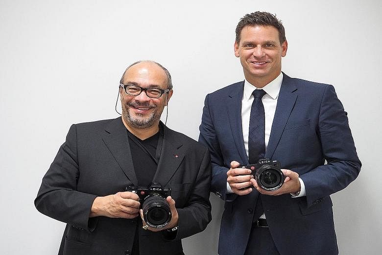 Leica chairman Andreas Kaufmann (left) and CEO Oliver Kaltner with the SL camera. It is targeted at professional photographers and serious amateurs. Leica's production line at Leitz Park in Wetzlar. The new SL series fills the gap between the M serie