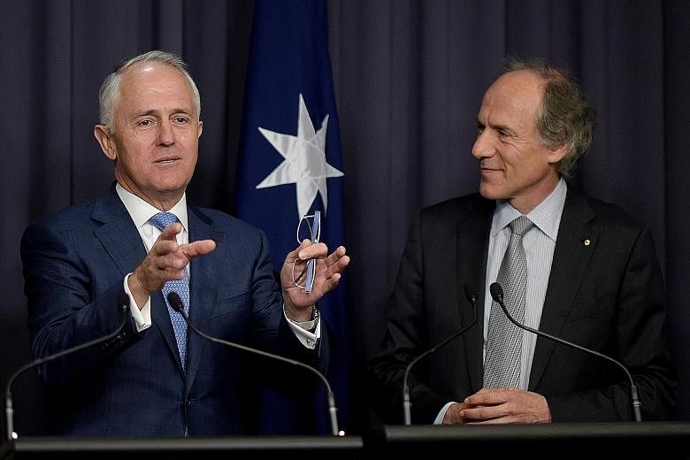 Australia's PM Malcolm Turnbull (far left) with incoming chief scientist Alan Finkel (left) at a press conference yesterday. Dr Finkel has advocated for an end to coal-fired power.