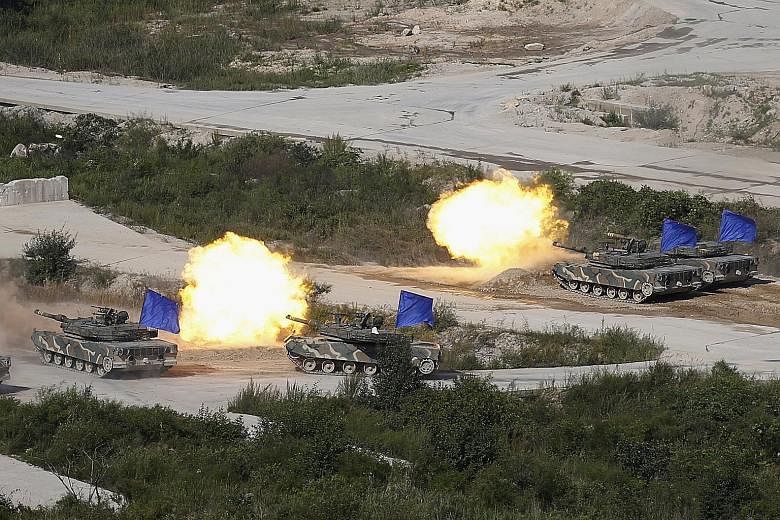 South Korean army K1A1 tanks in an exercise in a field near the demilitarised zone separating the two Koreas in Pocheon.