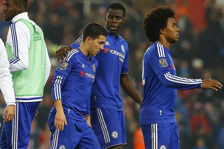 Eden Hazard (left) is consoled by Kurt Zouma after his penalty kick is saved by the Stoke custodian, ending Chelsea's defence of the League Cup.