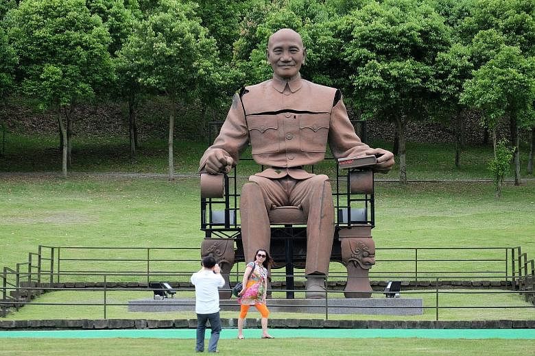Chinese tourists visiting the statue of the late nationalist leader Chiang Kai-shek in a park in northern Taoyuan in May. Taiwan's government has said China will not radically cut the number of tourists it allows in around election time, but admits t