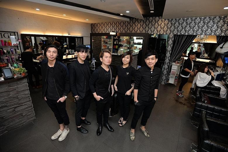 Vintage Studio director Vincent Ang (centre) with hairstylists (from left) Eugene Ng, Dowan Kim, Tracey Chin and Kidd Liang at the chain's Westgate outlet.