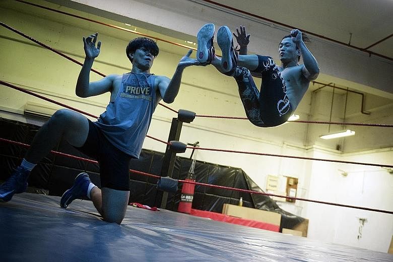 A week before the Singapore Pro Wrestling (SPW) show, Prove 5, Caleb Tan (left), practises with SPW co-founder Andruew Tang on Oct 17. SPW has a school which trains its wrestlers, and prepares them mentally and psychologically.