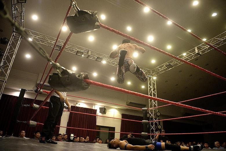 The Statement (Andruew Tang), 26, leaps into the air and finishes off Arsenal Affi (Muhammad Affi Aidat Othman), 25, at the main event of the recent SPW show, Prove 5. Storylines often pit a good guy against a bad one.