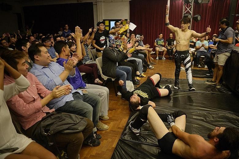 Sergeant Nick (Nicholas Lee), 23, riles up the crowd after grounding Australian wrestlers Renegade (Toby Kiddle, in black shirt), 21, and Lynx Lewis Jr (Sam Bradley, right), 22, during the SPW show, Prove 5, last Friday.