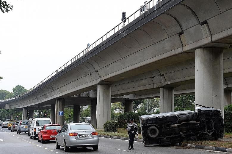 The lorry landed on one side after crashing into a bridge support pillar shortly after 8.30am yesterday. The 33-year-old driver, who was conscious, had to be extricated from the wreckage.