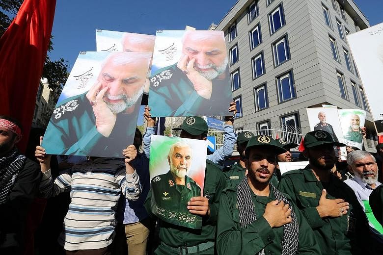 Members of the Revolutionary Guards at an Oct 11 funeral procession in Teheran for top commander Hossein Hamedani, who was killed in Syria. This week's talks on ending the Syrian conflict will be the first time the US will enter formal negotiations w