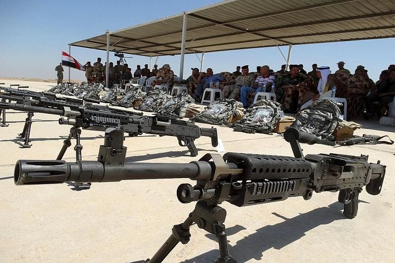 Weapons from the US presented to Sunni tribesmen during a ceremony at Camp Habbaniyah, in Ramadi, last month.