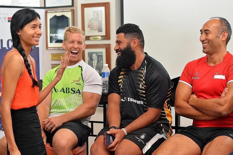 Master of ceremonies Dipna Lim-Prasad with (from left) South Africa sevens captain Kyle Brown, Will Hafu of the UK Penguins and Singapore's Daniel Marc Chow at the Singapore Cricket Club yesterday, before the International Rugby 7s tournament this we