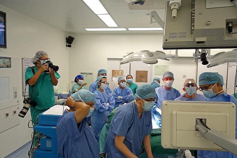 The transplant team looking at an ultrasound after the liver was implanted to ensure that all the vessels were working. Photojournalist Wang Hui Fen (far left) was in the operating theatre for the 12-hour transplant operation on Aug 1. Jeremy looking