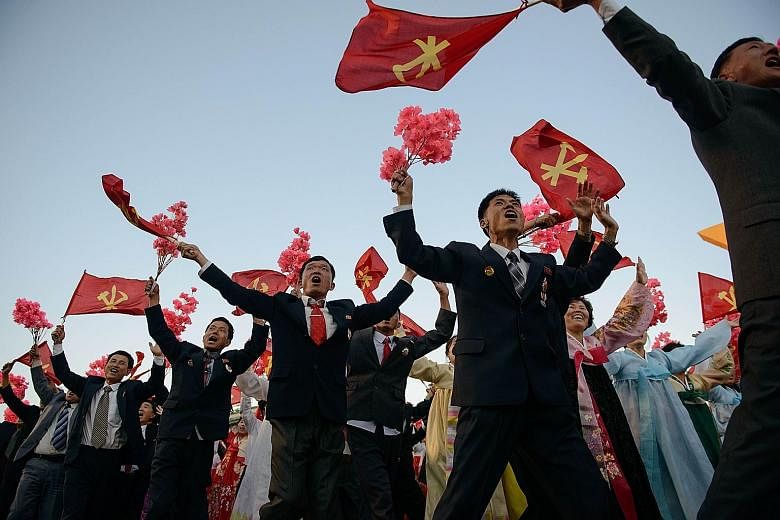 A mass parade in Pyongyang on Oct 10 to mark the 70th anniversary of the Workers' Party. The party emblem, which bears the communist hammer and sickle, also incorporates a calligraphy brush to symbolise the working intellectual.