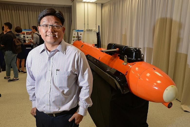 Mr Goh Ing Nam, DSO's Sensors Division programme director, with the M400 Autonomous Underwater Vehicle.