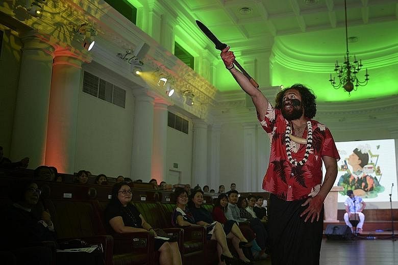 Performance poet Daren Kamali holding a Wau, a Fiji warrior weapon, during the Stories From Islands, Songs From Islanders II readings at The Arts House yesterday.