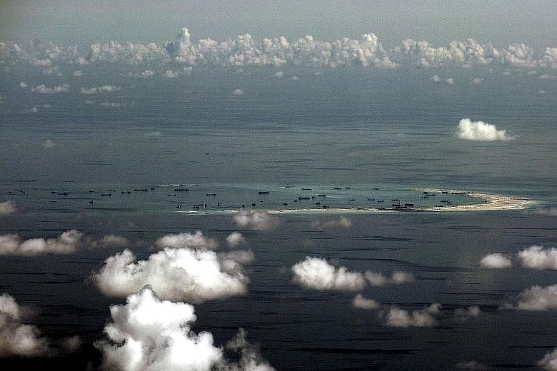 An aerial photo taken from a Philippine military plane shows the alleged ongoing land reclamation by China on Mischief Reef in the South China Sea. China has rebuked the US after the USS Lassen, a guided-missile destroyer, sailed within 12 nautical m