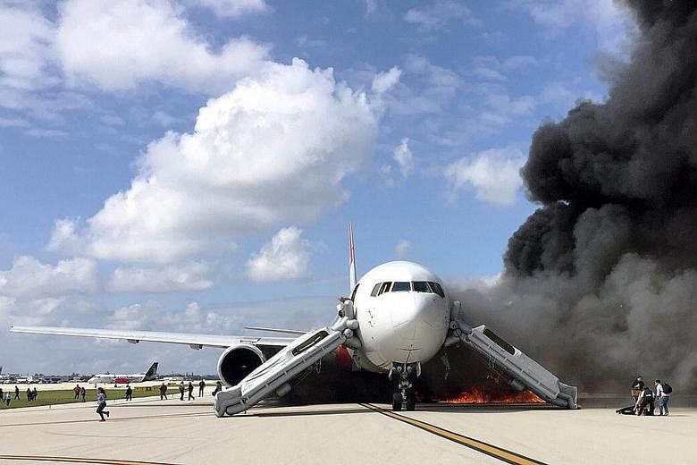 Black smoke billowing from the plane after an engine caught fire as it was taxiing for take-off on a runway at the Fort Lauderdale airport in Florida on Thursday. Officials said there were 101 people on board.