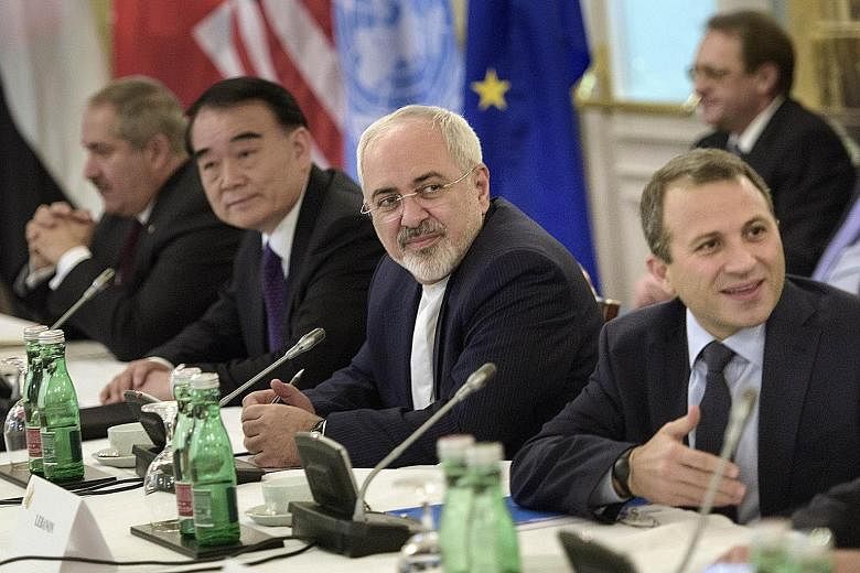Iranian Foreign Minister Javad Zarif (second from right) and Chinese Vice-Foreign Minister Li Baodong (second from left) waiting with others before a meeting in Vienna to discuss solutions to the conflict in Syria.