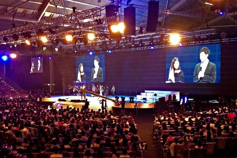 Pastor Kong Hee and his wife, Ms Ho Yeow Sun, on stage during a City Harvest service in 2012. The 140-day trial of the City Harvest Church leaders, which took place over two years, was a delicate balancing act for a secular state.
