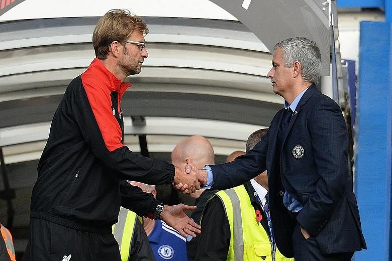Liverpool manager Juergen Klopp, shaking hands with Chelsea manager Jose Mourinho at the end of the match, gets his first league victory after taking over.
