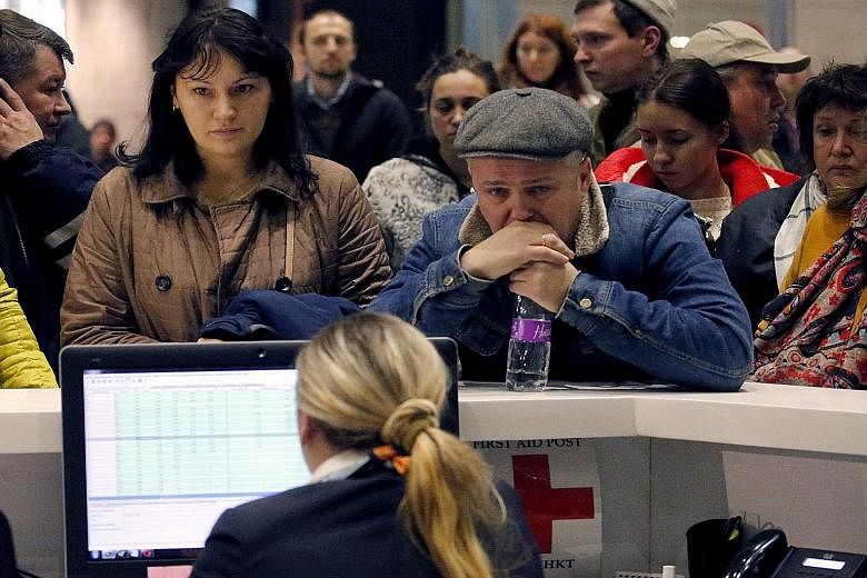 Relatives of passengers of Metrojet Airbus A-321, operated by Russian airline Kogalymavia, waiting anxiously at an information desk at Pulkovo II International Airport in St Petersburg, Russia, yesterday. Many reeled in shock after news of the plane 