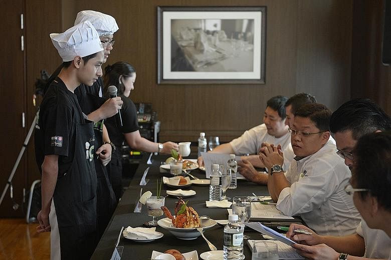 The proof is in the pudding or, in this case, the chilli crab. Here, students Ian Wee (with microphone) and Fahd Shah Mohammad Nizam (far left), both 15, present their dishes - chilli crab and bubur chacha - to the iChef Challenge judges.