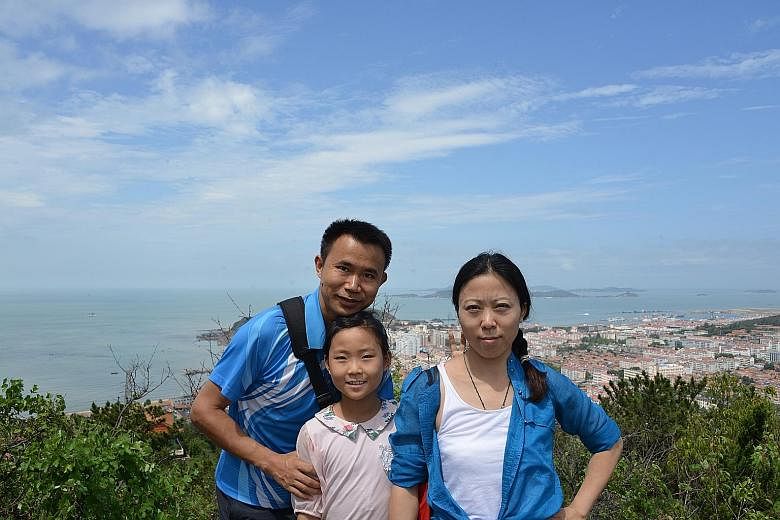 Ms Carol Feng with her husband Qu Hua and their 10-year-old daughter Shuyuan. The family lives in Beijing.