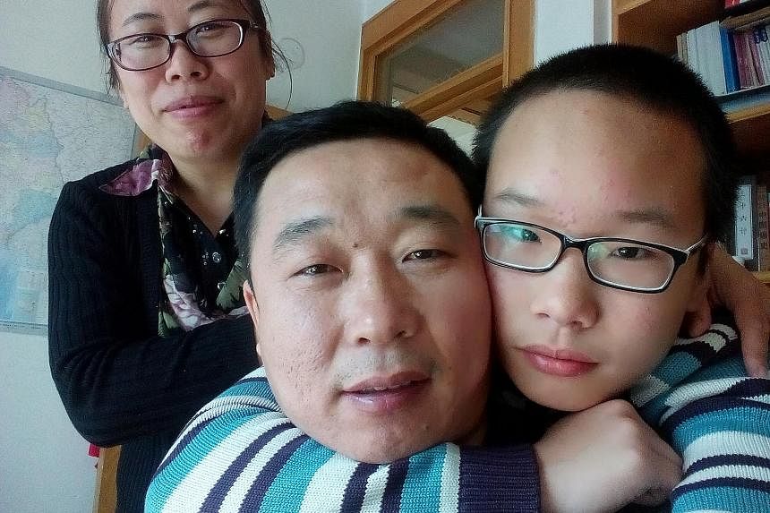 HOPING FOR ANOTHER CHILD: Ms Deng Xiaen with her husband Zhou Jie and their four-year-old daughter Yutong. The couple have decided to have a second child after initially grappling with a decision. FILLED WITH REMORSE: Ms Jin Hongyan with her husband 