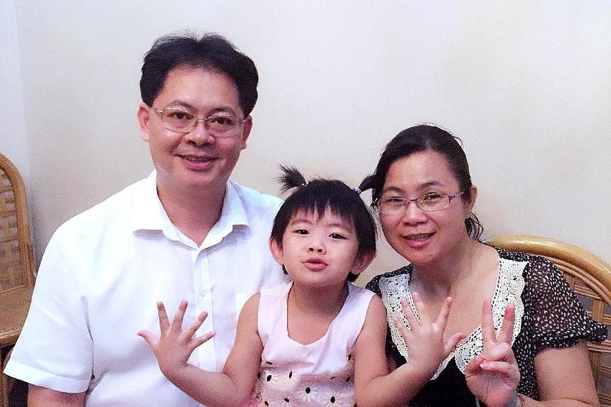 HOPING FOR ANOTHER CHILD: Ms Deng Xiaen with her husband Zhou Jie and their four-year-old daughter Yutong. The couple have decided to have a second child after initially grappling with a decision. FILLED WITH REMORSE: Ms Jin Hongyan with her husband 