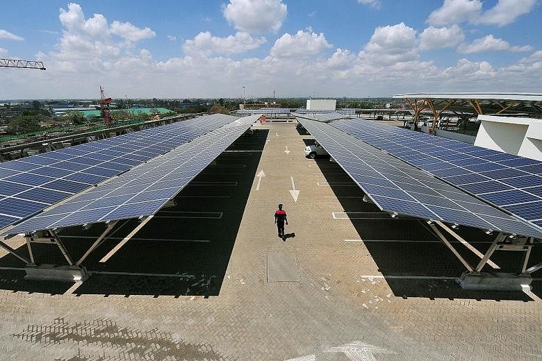 A carpark with rooftop solar panels that also help shade parked cars, at the Garden City Mall in Nairobi. The carpark, opened recently at the shopping mall, is Africa's largest solar carpark and aims to cut carbon emissions by 745 tonnes annually fro