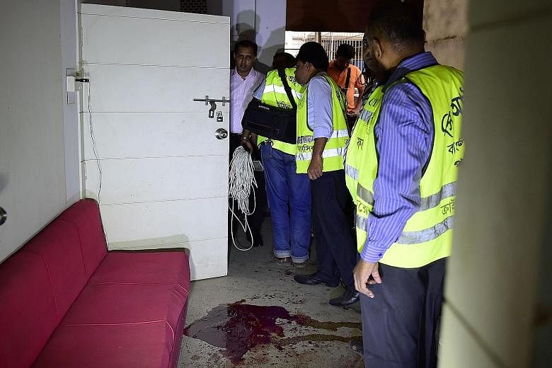 Bangladeshi police examining the scene of an attack on publisher Ahmedur Rashid Tutul, along with two secular bloggers, in an office in Dhaka on Saturday. The government has been accused of failing to halt the rise in deadly violence blamed on hardli