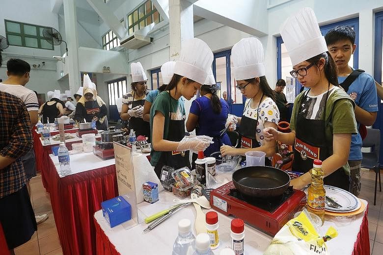 Participants at a dessert-making competition at Geylang Serai Community Club yesterday. Marine Parade GRC MP Fatimah Lateef said, on the sidelines of the event, that she is training grassroots leaders to explain the new healthcare policy to residents