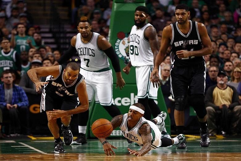 San Antonio guard Tony Parker (left) and Boston guard Isaiah Thomas diving for a loose ball. The Celtics tried to fight back from a 15-point deficit but could get no closer than four before losing 87-95.